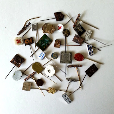 Selection of vintage enamelled tie pins in various shapes and colours.