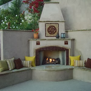 Outdoor living area with a fireplace featuring a ceramic tile Pomegranate mural