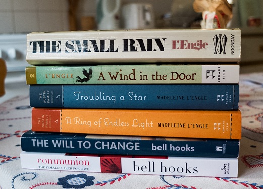 Pile of books: The Small Rain, A Wind at the Door, A Ring of Endless Light and Troubling a Star by Madeline L'Engle and The Will to Change and Communion by bell hooks