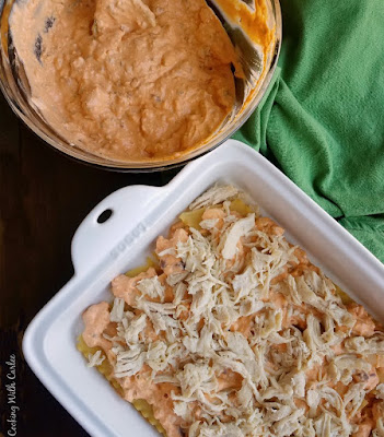 layers of lasagna noodles, creamy buffalo sauce and chicken in pan