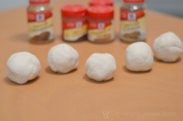 This no-cook play clay recipe is perfect for autumn arts and crafts.  Add Fall scents like pumpkin and apple to easily make a variety of fun dough for kids to use in activities. #fallplaydough #fallplaydoughrecipes #fallcrafts #nocookplaydoughrecipes #nocookplaydough #nocookclayrecipe #playclay #pumpkinclay #appleplaydough #fallclayprojects #growingajeweledrose #activitiesforkids