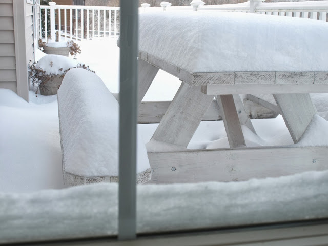 White picnic table covered in winter white snow by Hello Lovely Studio