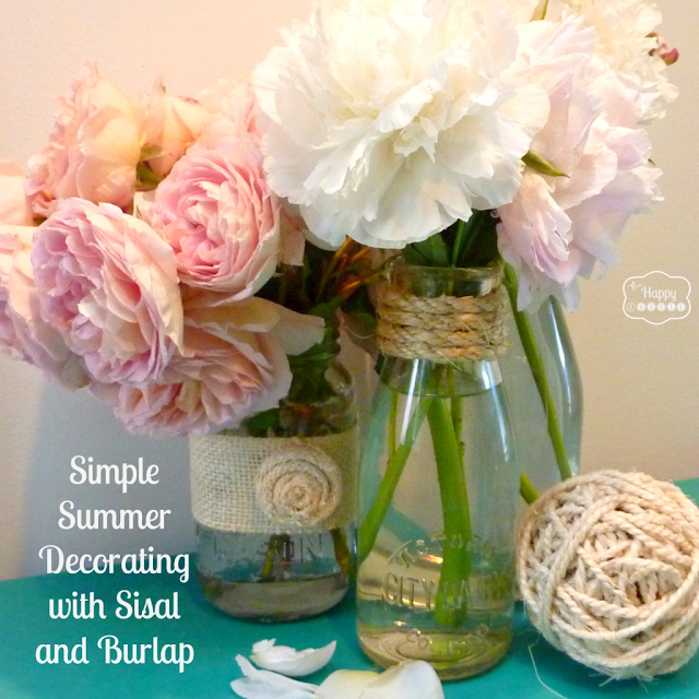 Sisal and burlap touches on plain mason jars and vintage milk bottles, by The Happy Housie, featured on I Love That Junk. Very sweet and simple!