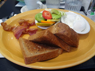 Poached eggs, bacon, wheat toast, fruit bowl at Sophie's Cosmic Cafe, Light Breakfast, Vancouver