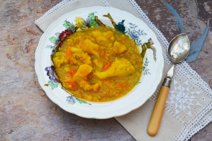 a bowl of spiced cauliflower and carrot soup