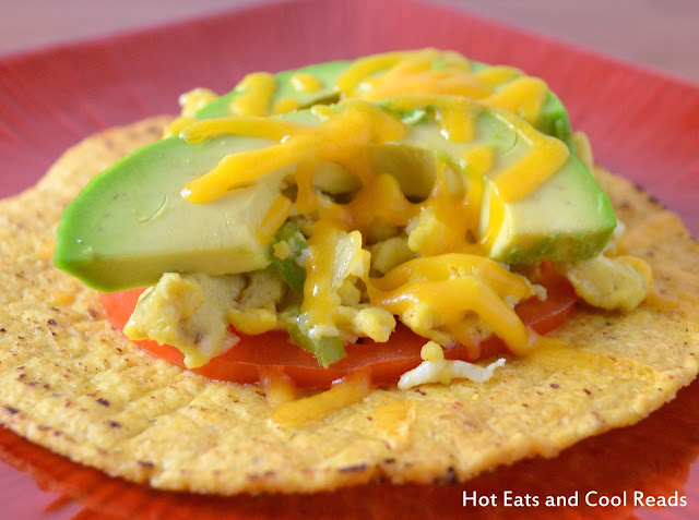 Cheesy Scrambled Egg and Avocado Tostadas Recipe from Hot Eats and Cool Reads! This breakfast can be ready in 15 minutes! Great for busy weekday mornings or add it to your weekend brunch!