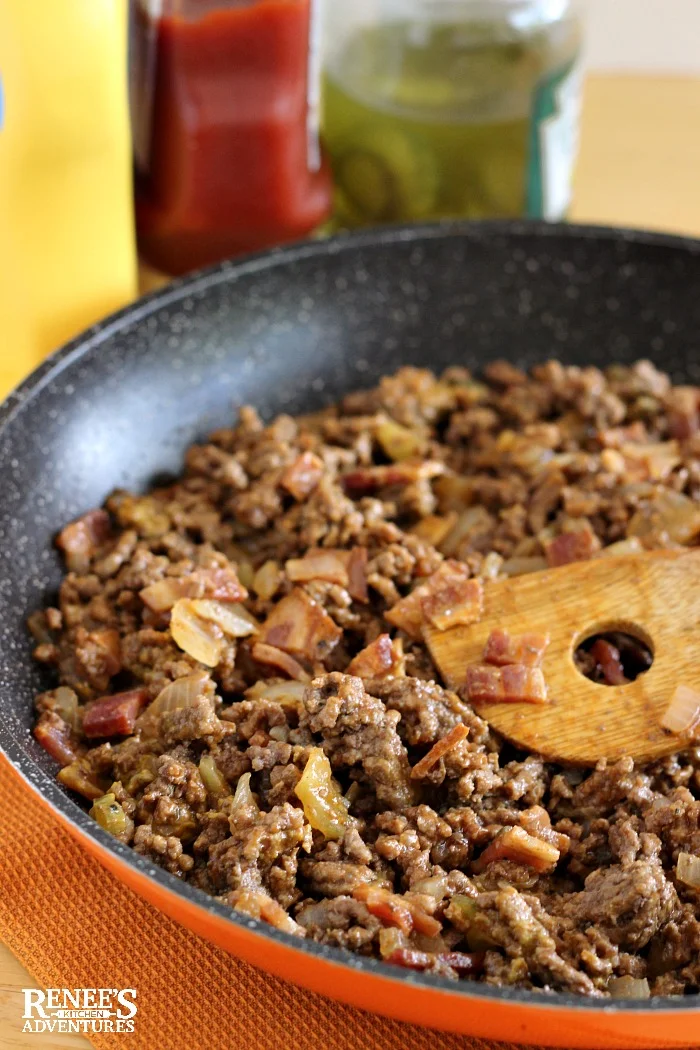 Cheeseburger Casserole Recipe seasoned ground beef in pan with bacon