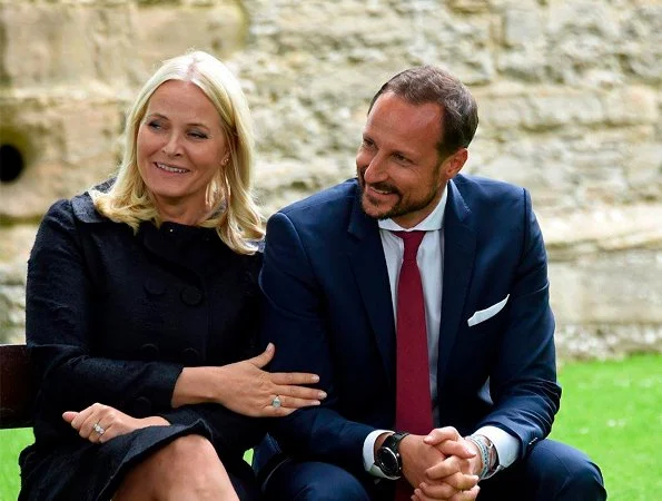 Crown Princess Mette-Marit and Crown Prince Haakon attended St. Magnus festival in Scotland. Prada dress, Christian Louboutin pumps
