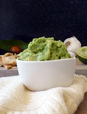 Simple Guacamole Recipe | by Life Tastes Good is plain and simple with some garlic, salt and a touch of lime juice. That's it! Smoosh all that together and give me some chips and get outta my way...so I don't run you over on my way to the couch! #Appetizer #Avocados