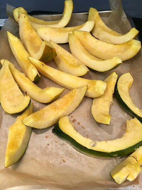 slices of acorn squash on a cookie sheet