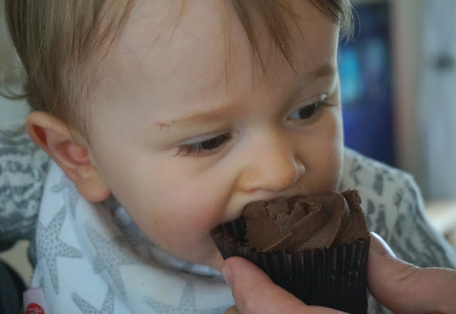 baby boy eating chocolate cupcake