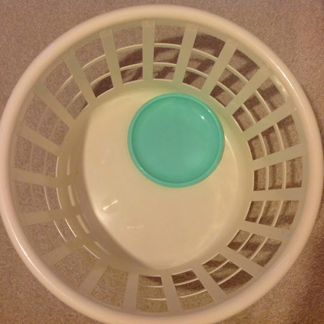 picture of a laundry basket with a blue plastic plate in it