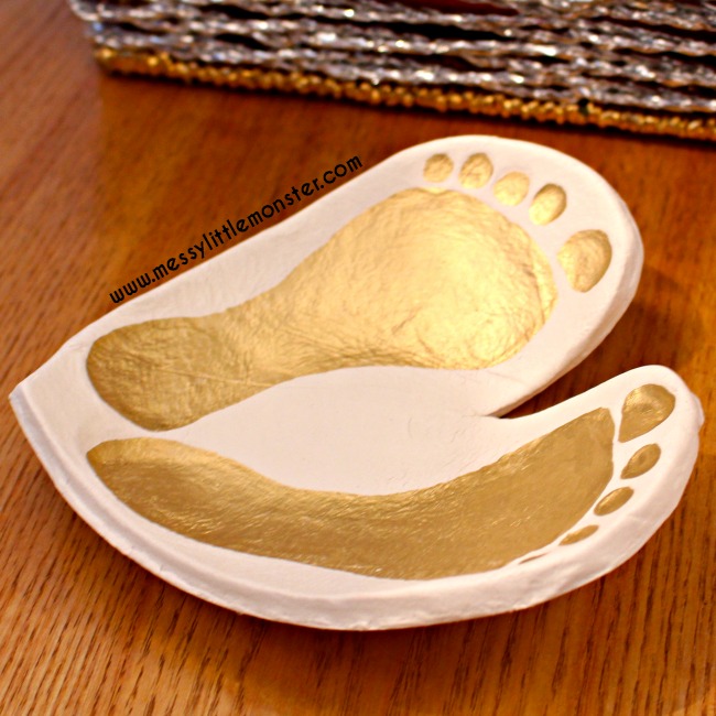 Learn how to make a clay footprint bowl keepsake using our easy diy instructions. Use baby or toddler footprints and air dry clay to make a heart ring dish craft to treasure. An easy homemade gift idea for parents or grandparents.