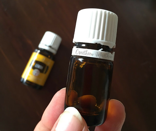 Removing bottle labels and adhesive with lemon essential oil