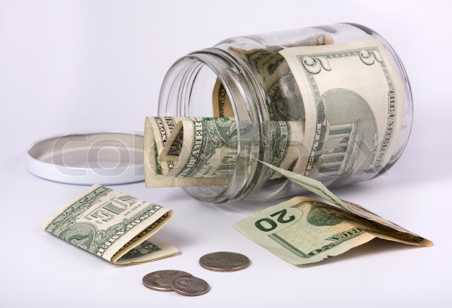 an open glass jar with money