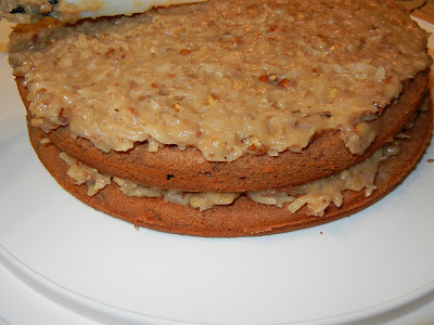 coconut and pecan Spread in between the cake layers and frost the cake with it.