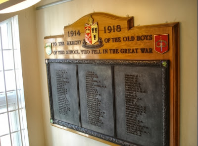 Three bronze coloured panels set on a wooden board.  Each panel has a long list of names, but they are too small to read and there is no transcription on the War Memorials Online website as yet.