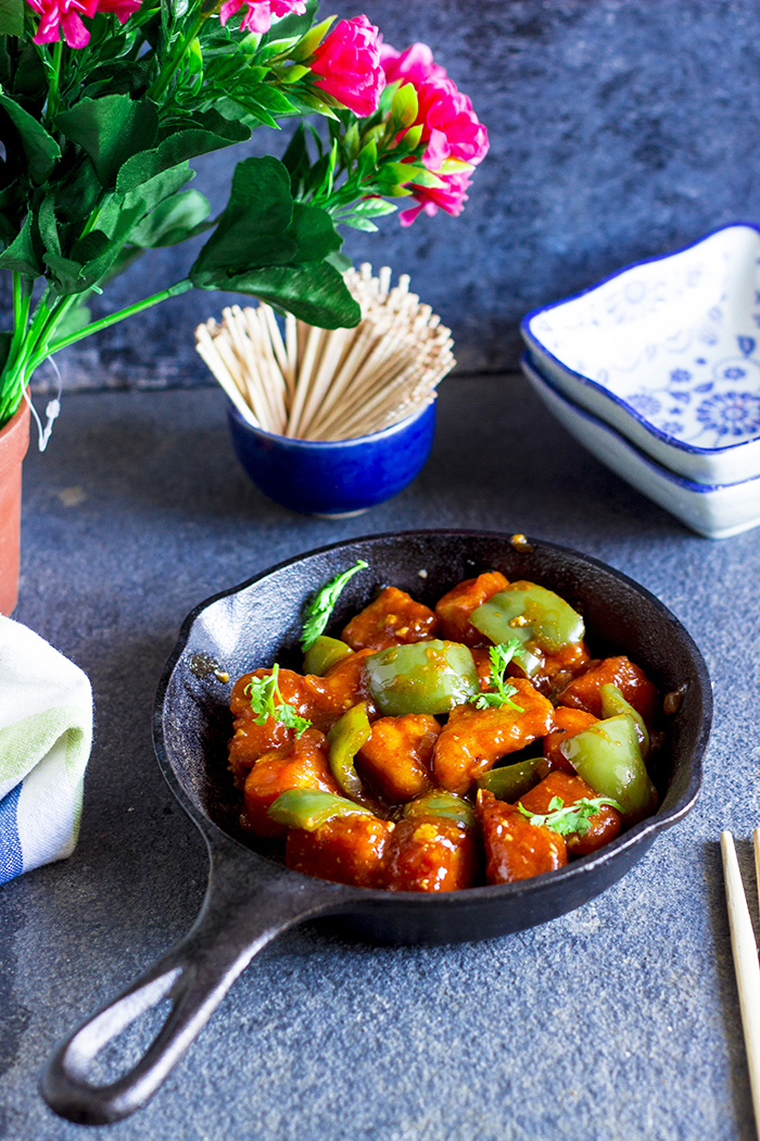 Batter fried tofu in a spicy chinese sauce with green capsicum