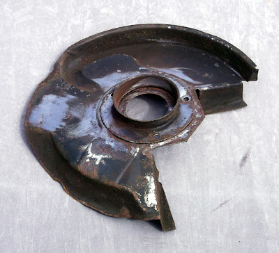 Image of an Opel Manta brake disc back plate on a grey background