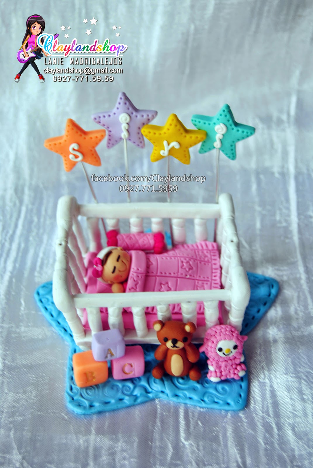 Clayland Souvenir Shop Baby sleeping in a crib cake topper