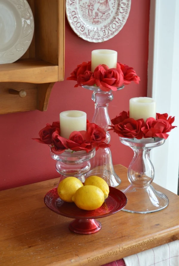 Floral DIY Candle Rings on candles with lemons on a small red cake plate nearby