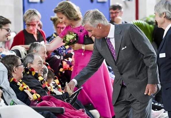 Queen Mathilde wore a pink asymmetric midi dresses by Natan.Arthur Regniers medical and pedagogical center