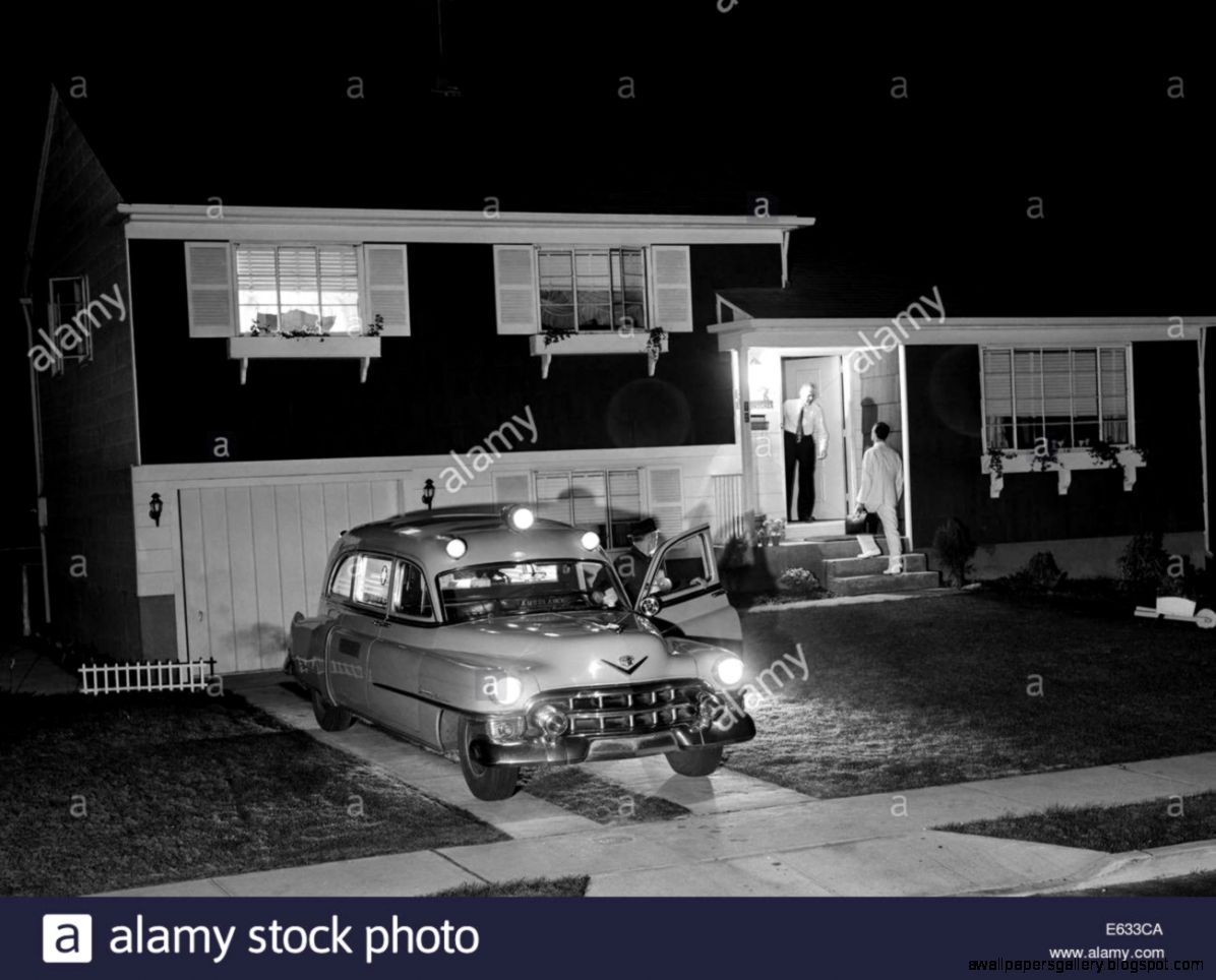 1950s Ambulance At Night Parked In Suburban Home Driveway With