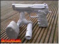 aluminum pistol casting with sprue and riser