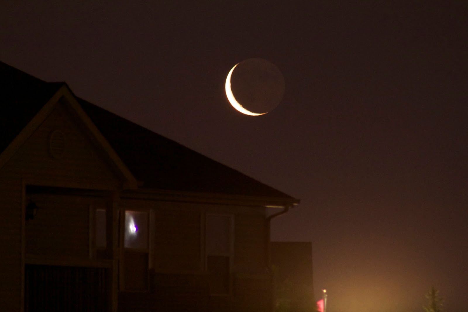 crescent moon over roof