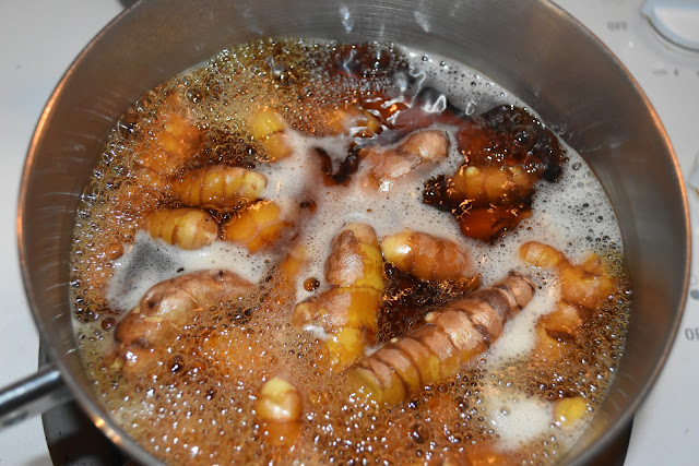 Boiling homegrown turmeric rhizomes in water