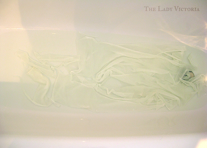 white fabric in bleach in a bathtub