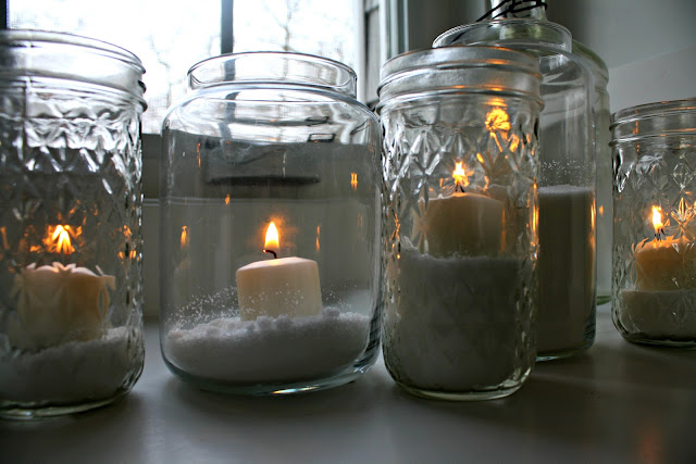 A table topped with glasses of wine, with Candle