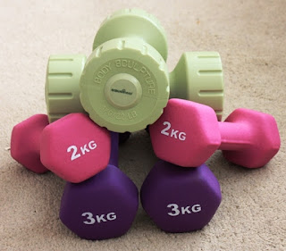 Picture of all my new weights stacked up on the floor