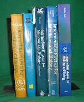 A photograph of all five editions of Intermediate Physics for Medicine and Biology.