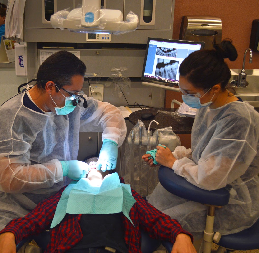 Image of dental students working with a young patient.