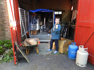 boy scout loading wagon with camping equipment