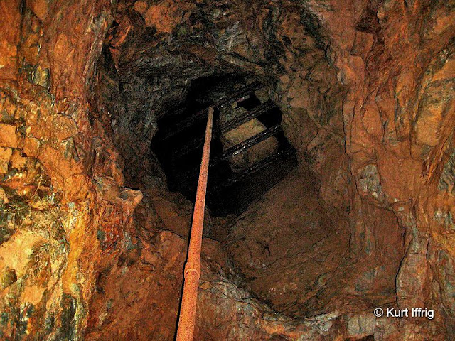 A water pipe leading up one of Big Horn Mine's shaft to an upper level. Grating was added to protect miners from falling rocks.
