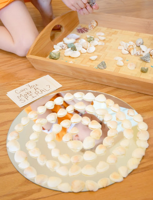 Shells And Mirrors On The Discovery Table. Independedent activity to encourage quiet exploration and loose parts play with natural materials. Fun for a beach or ocean theme for preschoolers or kindergarten, incorporating math, science, and art!
