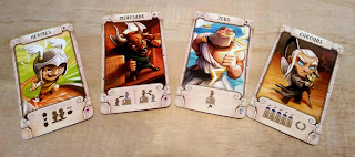 Four cards, each with a cartoon representation of a character from Greek Mythology: Hermes, the Minotaur, Zeus, and Chronos. The first two have a small flower icon in the lower right corner; the other two have a blue spiral icon in that place.