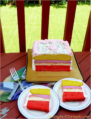 Lemon Raspberry Ice Cream Cake, two flavored cake layers, two ice cream layers and a crunchy center and frosted with whipped cream. A delicious summer treat. | Recipe developed by www.BakingInATornado.com | #recipe #dessert #cake