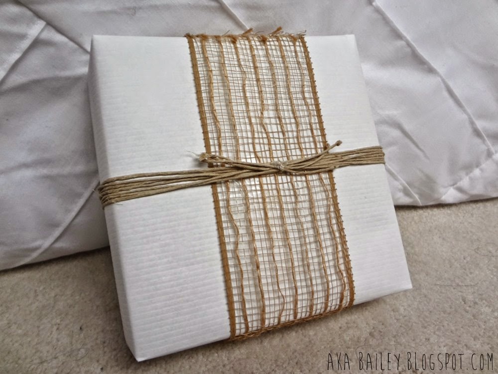 White gift wrap with burlap ribbon and hemp twine