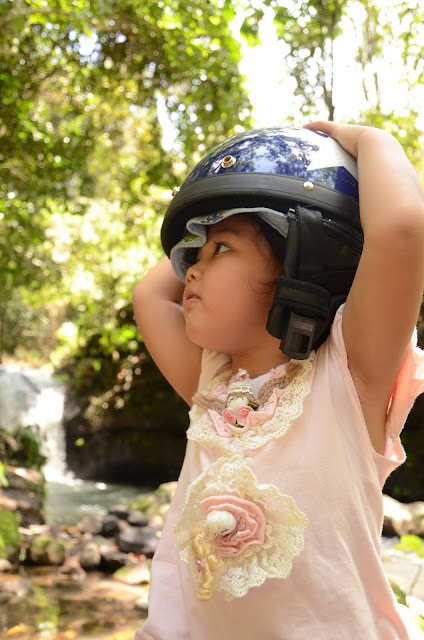 Kecil with helmet at the waterfall