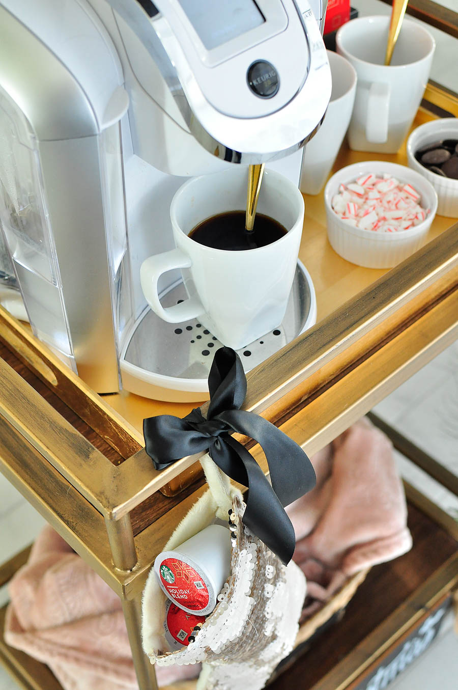 Turn a bar cart into a portable coffee cart (or coffee station) with Starbucks coffee and a Keurig. Perfect for a cozy holiday with the family!