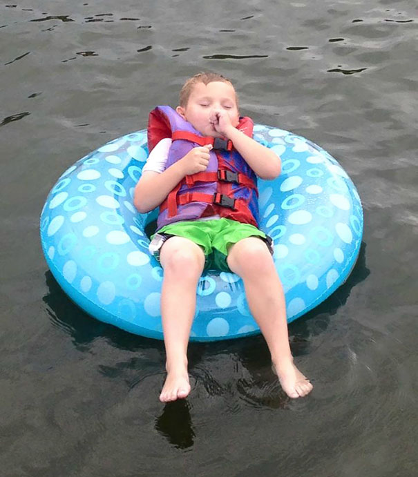 15+ Hilarious Pics That Prove Kids Can Sleep Anywhere - Napping On The Swim Ring