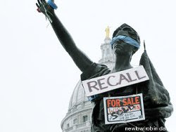 Forward statue with 'Recall' sign