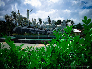 Krishna's Chariot Statue View From Fresh Green Leaves Of The Plants In The Garden At Tangguwisia Village, North Bali, Indonesia