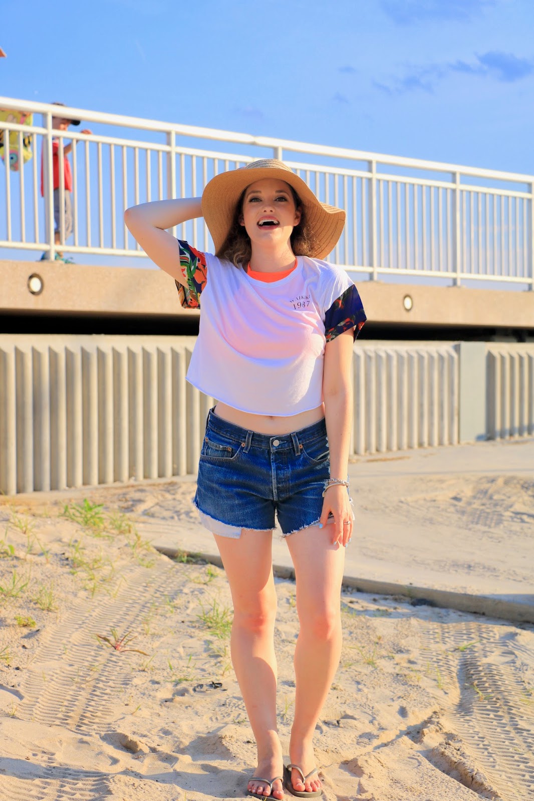 Fashion blogger Kathleen Harper in beach coverup cut-off denim shorts and crop top