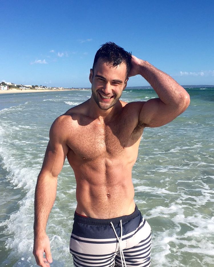 Cute shirtless beach boy