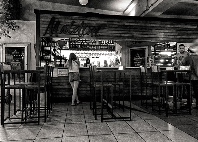 La chica en la barra. Interior en bar una chica enñla barra.