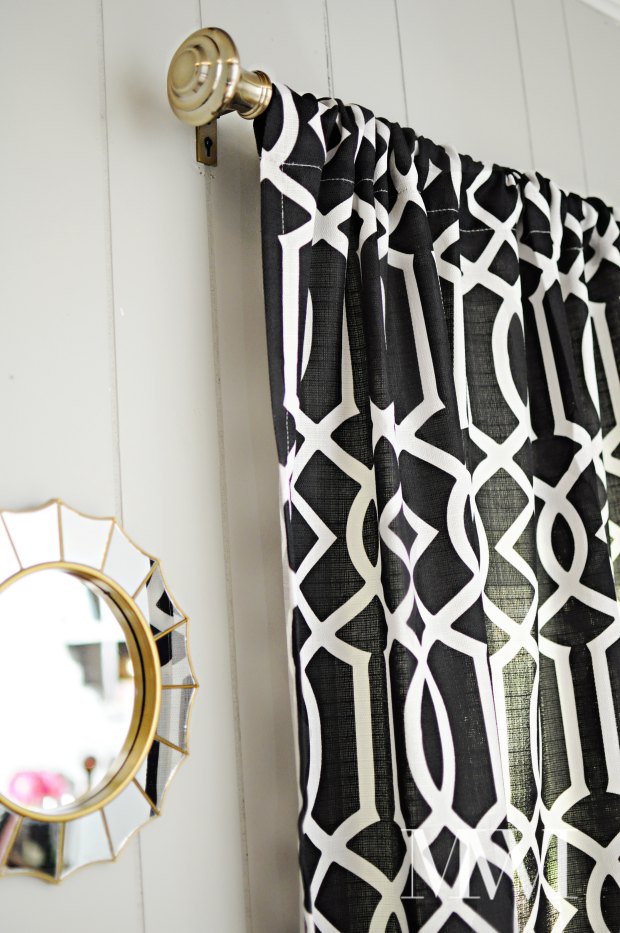 A beautiful use of bold black & white imperial trellis curtains paired with an antique brass curtain rod. All the decor is from the BHG line at Walmart and comes in under $50.